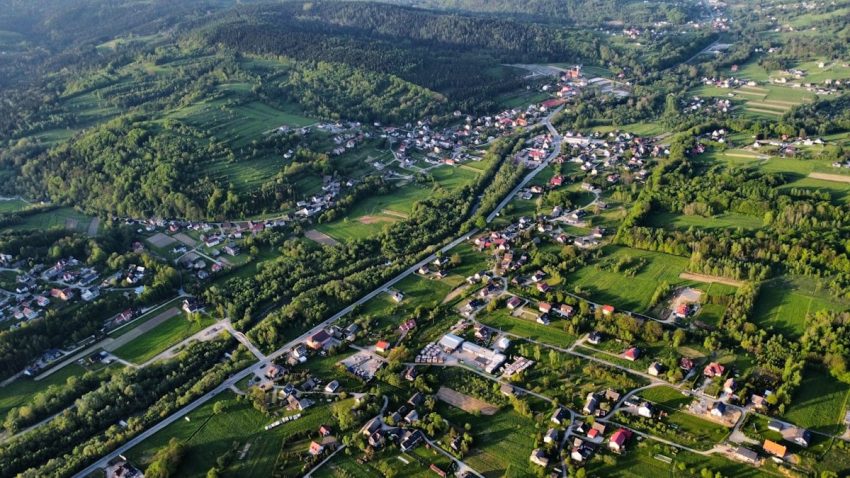 Aerial view of a lush valley and village.